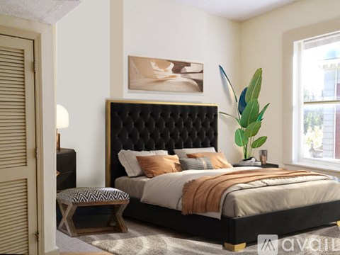 A bedroom with a large bed and a painting on the wall.