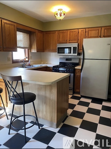 A kitchen with black and white checkered floor.