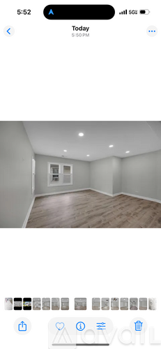 A room with wooden flooring and white walls.