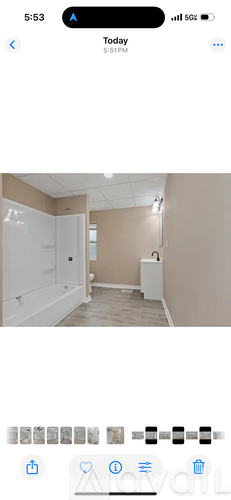 A white door is open in a room with beige walls.