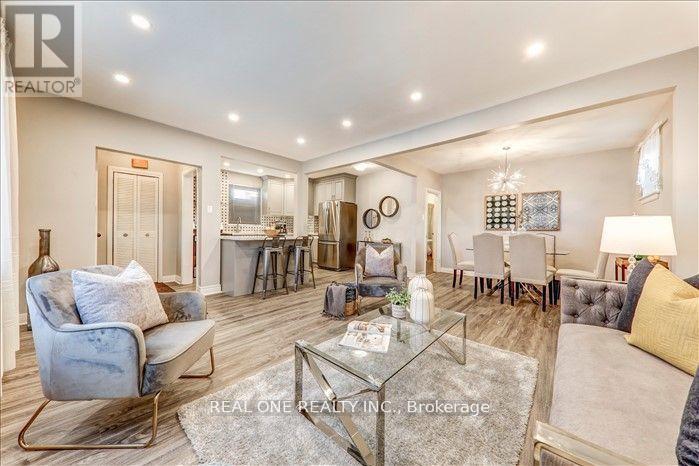 A well-lit, spacious living room with a glass coffee table and a blue armchair.