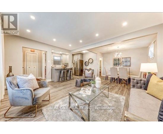 A well-lit, spacious living room with a glass coffee table and a blue armchair.
