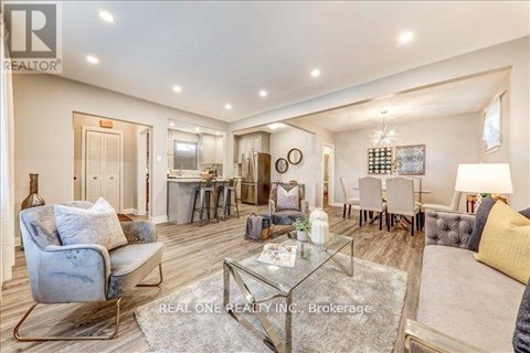 A well-lit, spacious living room with a glass coffee table and a blue armchair.