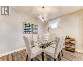 A dining room with a glass table and chairs.