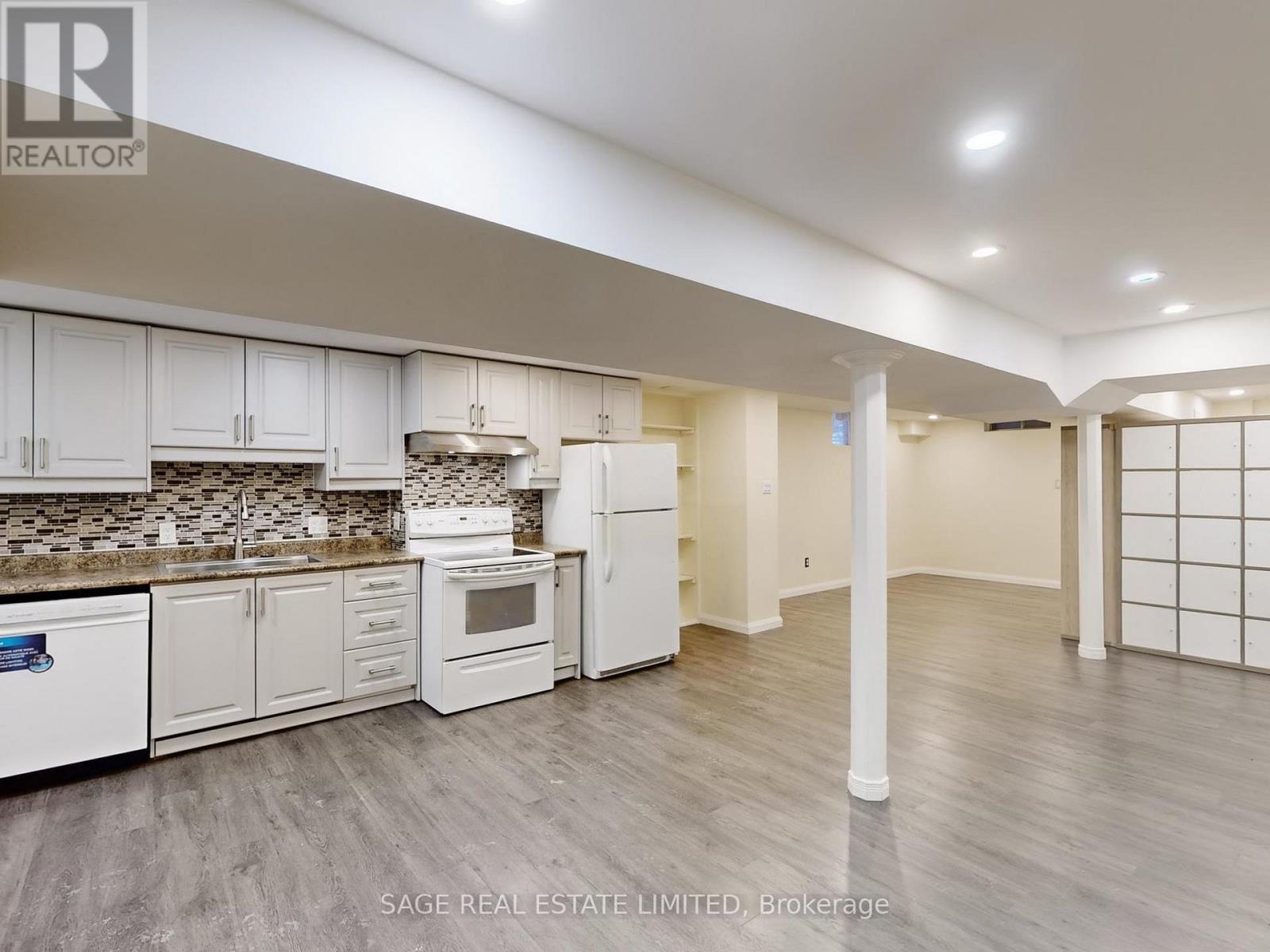 A kitchen with white cabinets and a tile backsplash.