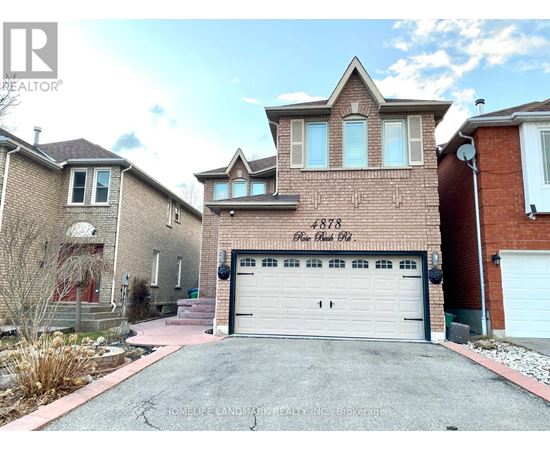 A brick house with a white garage door and the number 1783 on the brick wall.