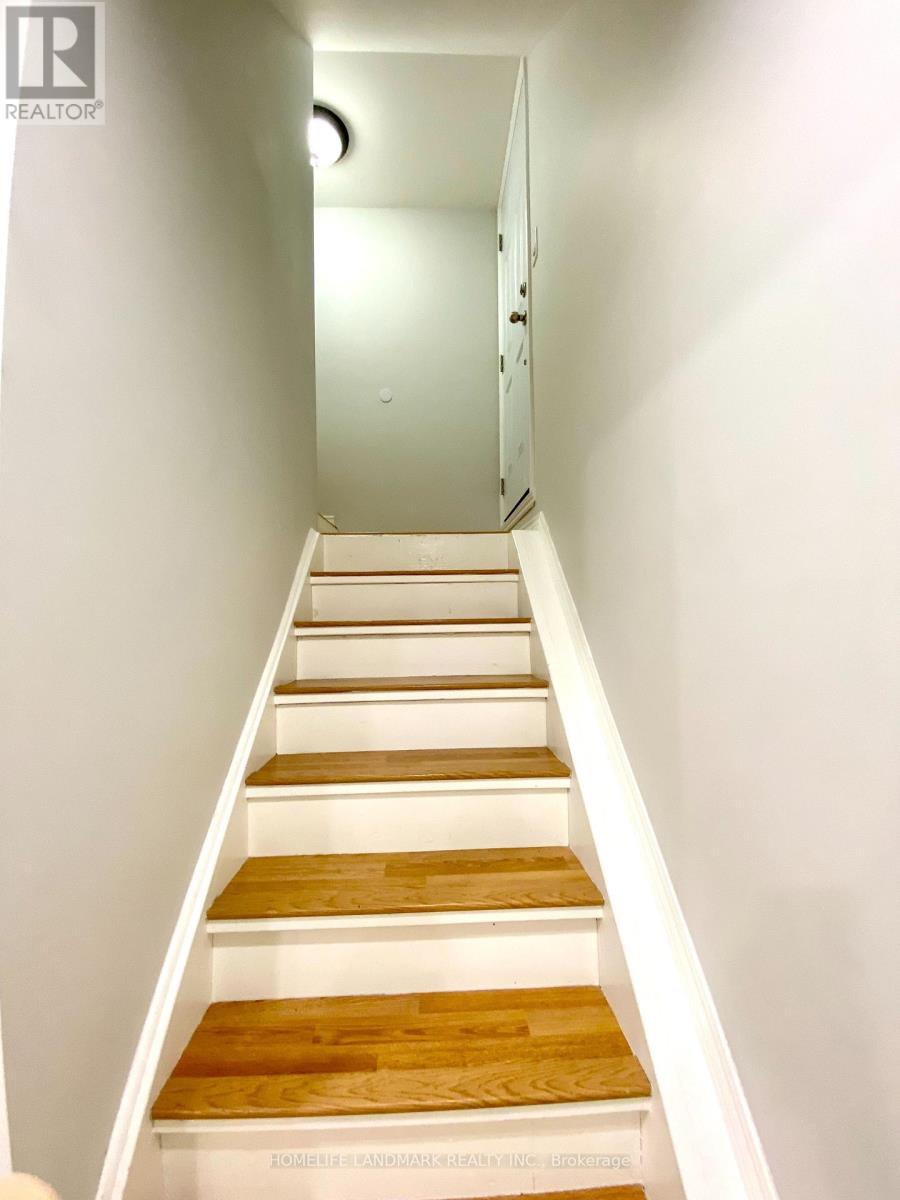 A set of stairs with white risers and wooden treads.
