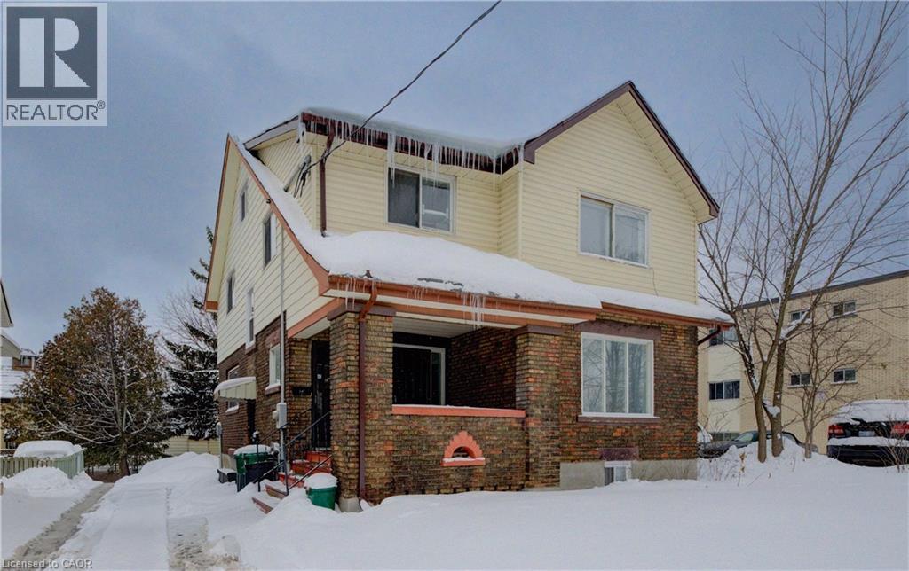 A house with a snow-covered front yard.