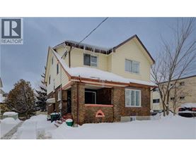 A house with a snow-covered front yard.