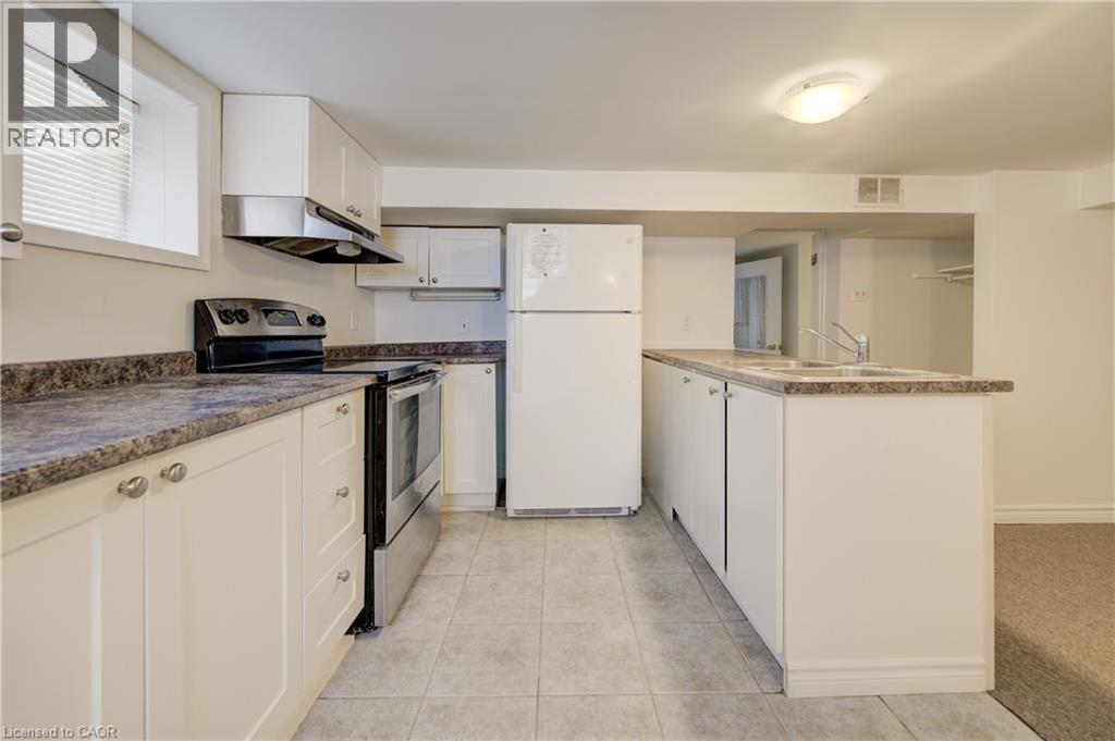 A kitchen with white appliances and cabinets.