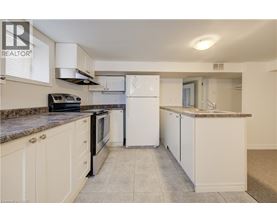 A kitchen with white appliances and cabinets.