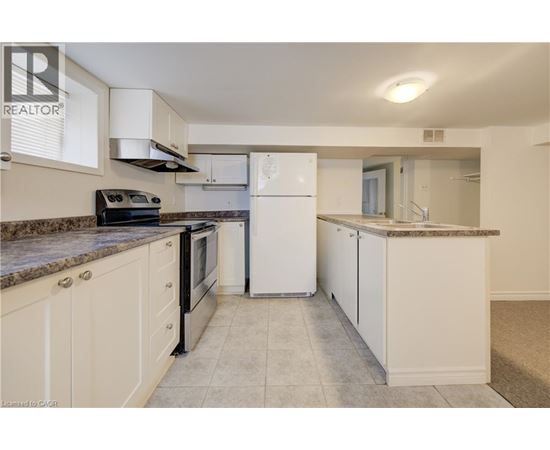 A kitchen with white appliances and cabinets.