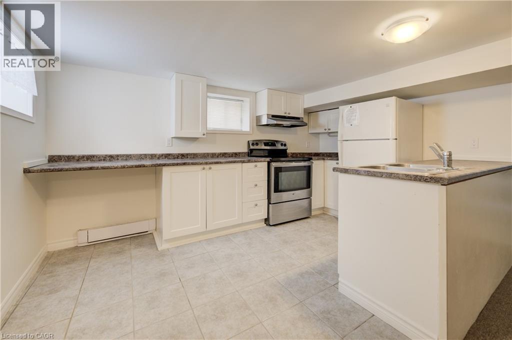 A kitchen with white cabinets and a granite countertop.