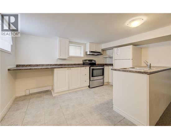 A kitchen with white cabinets and a granite countertop.