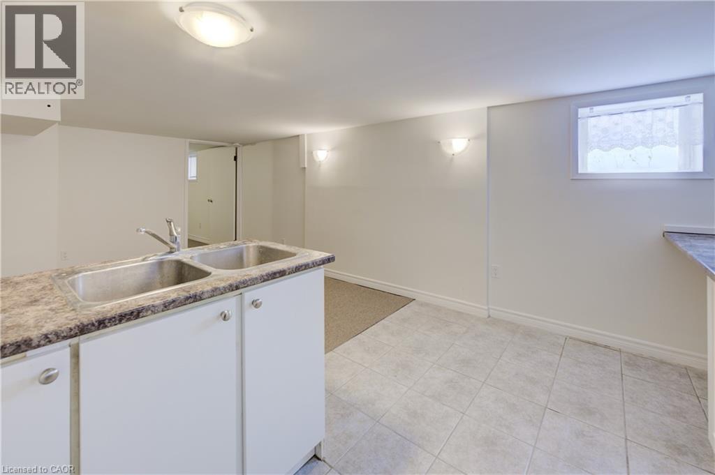 A kitchen with white cabinets and a granite countertop.