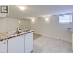 A kitchen with white cabinets and a granite countertop.