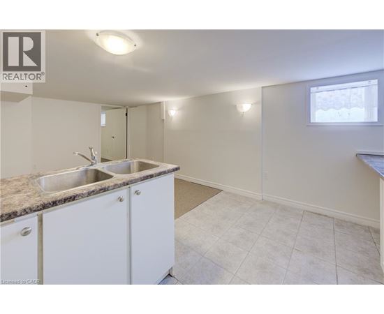 A kitchen with white cabinets and a granite countertop.