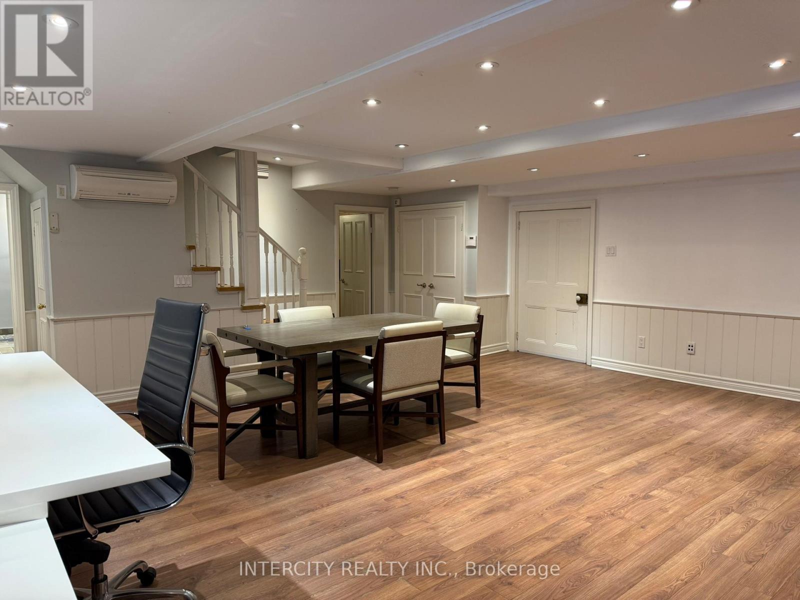A dining room with a table and chairs.