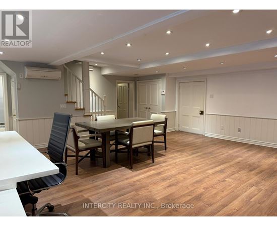A dining room with a table and chairs.