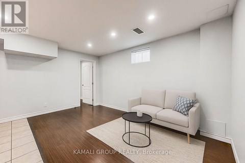 A living room with a white couch and a black coffee table.
