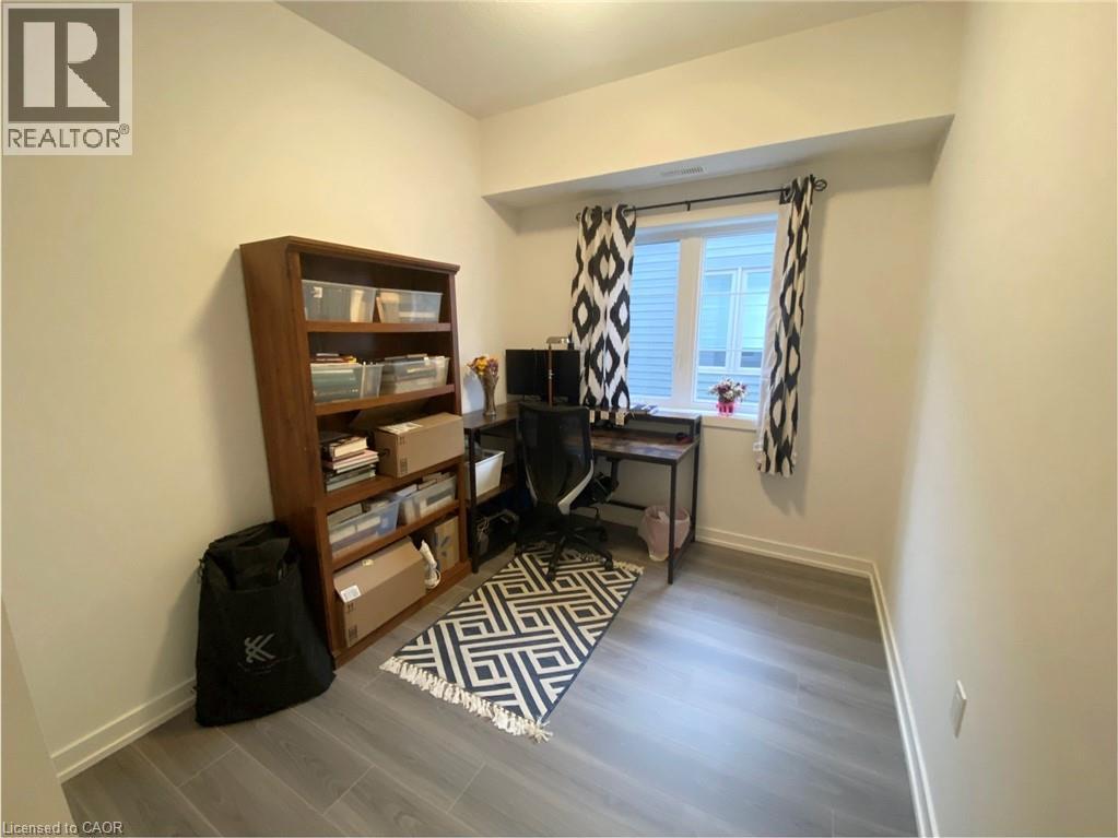 A living room with a TV, a bookshelf, and a rug.