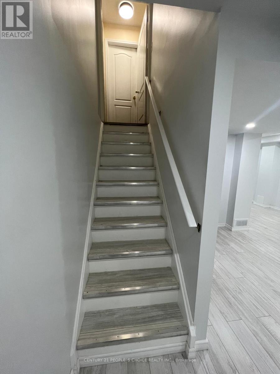 A staircase with wooden steps and a metal handrail.