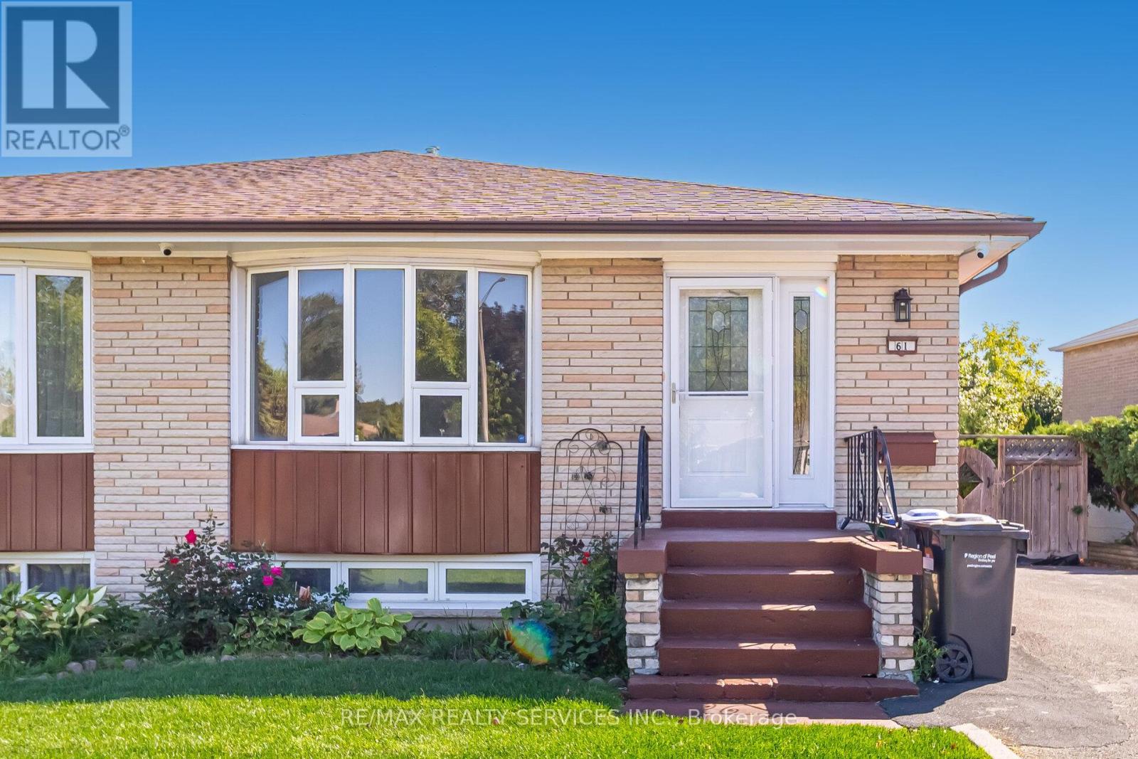 A house with a brown front door and a white window.