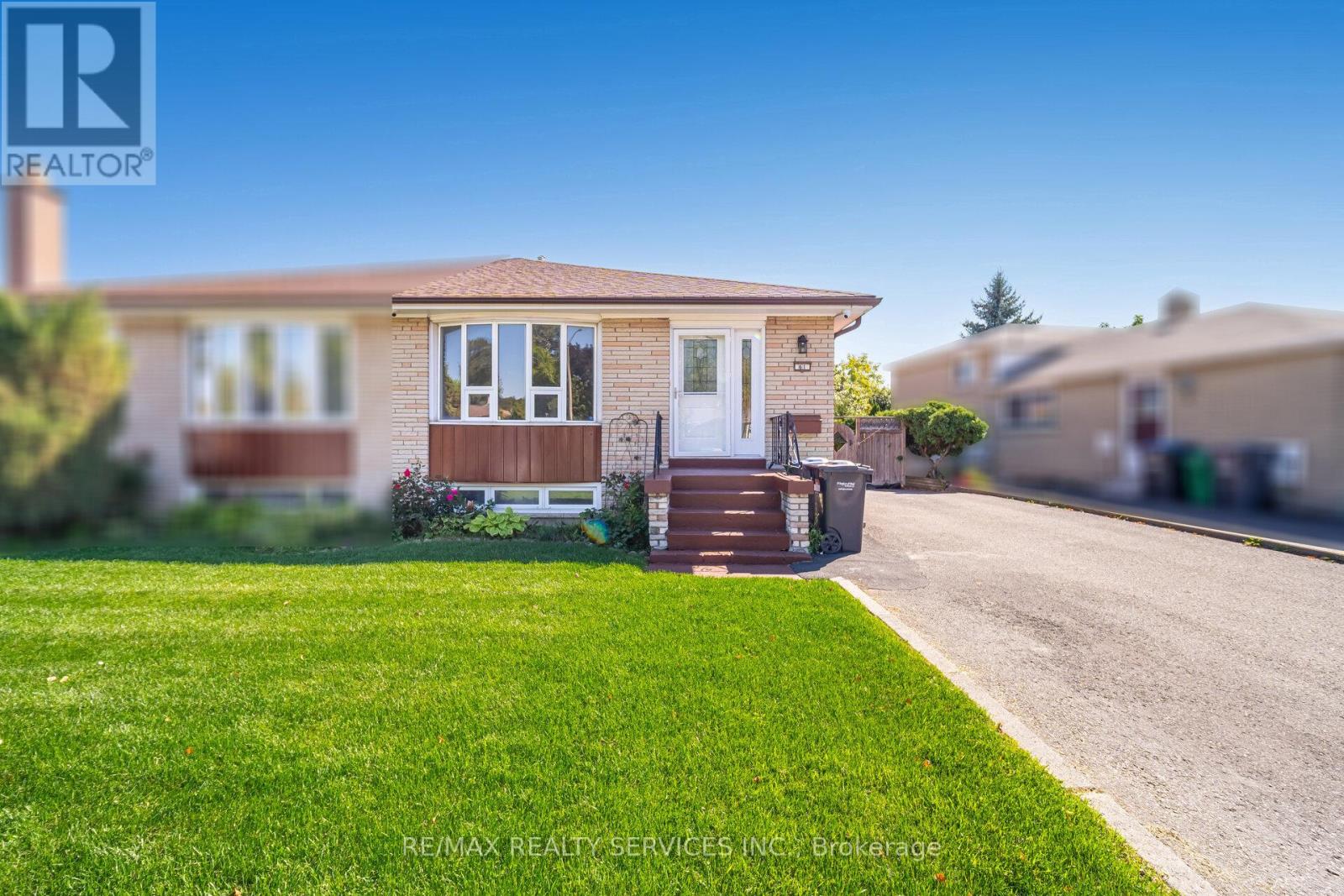 A house with a white door and a small front yard.