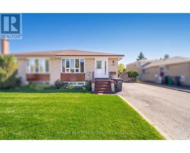 A house with a white door and a small front yard.