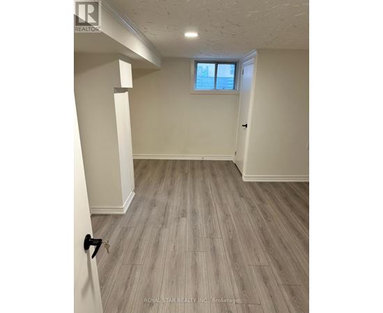 A room with a window and wooden flooring.