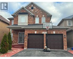 A house with a basketball hoop in front.