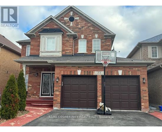 A house with a basketball hoop in front.