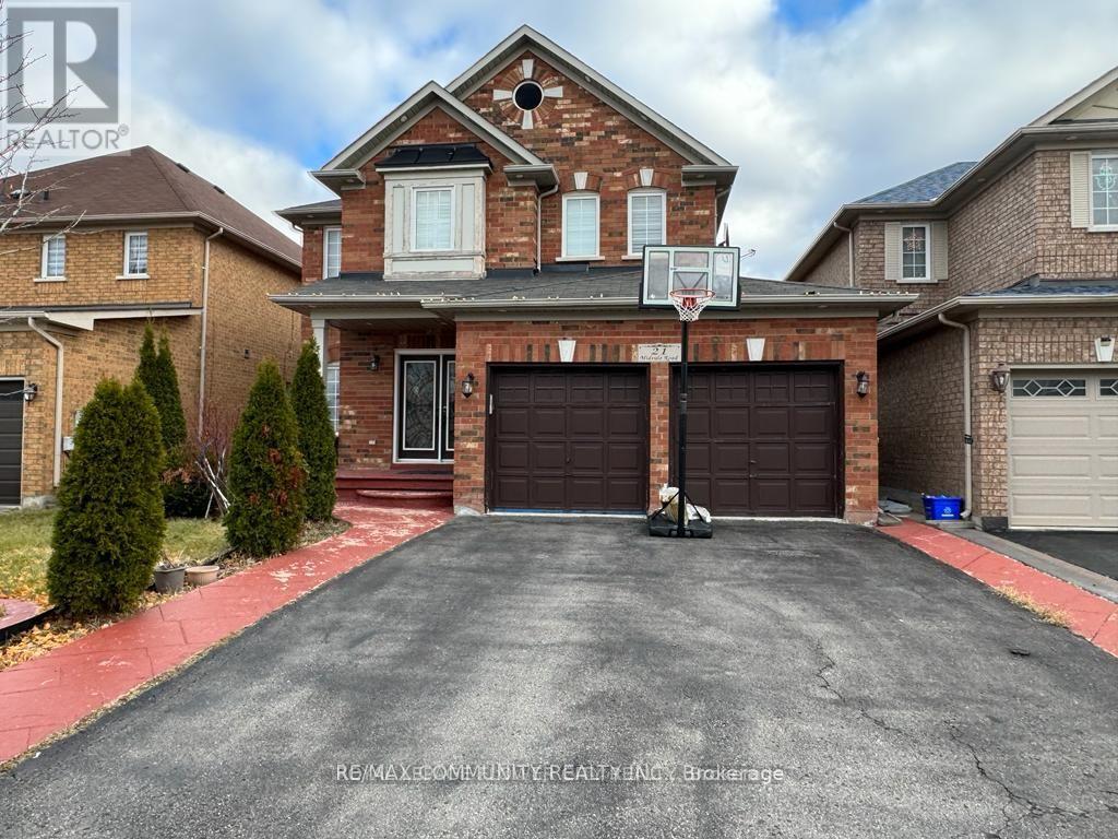 A house with a basketball hoop in the driveway.