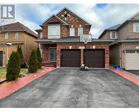 A house with a basketball hoop in the driveway.