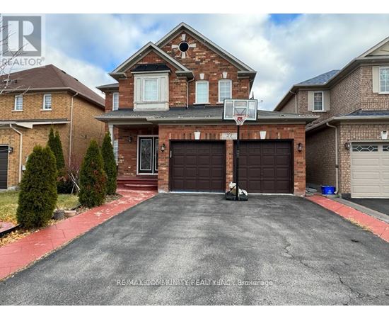 A house with a basketball hoop in the driveway.