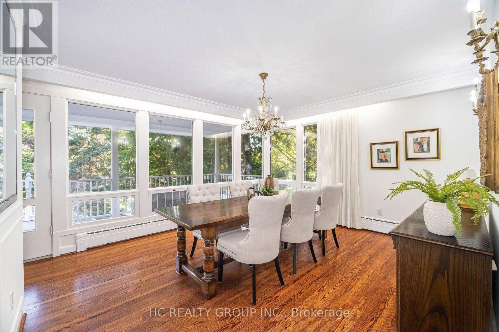 A dining room with a wooden table and chairs.