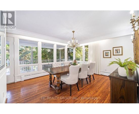 A dining room with a wooden table and chairs.