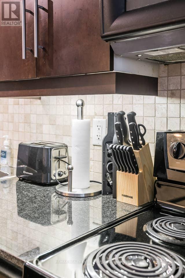 A kitchen counter with a toaster, knives, and a towel.