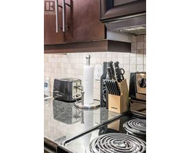 A kitchen counter with a toaster, knives, and a towel.