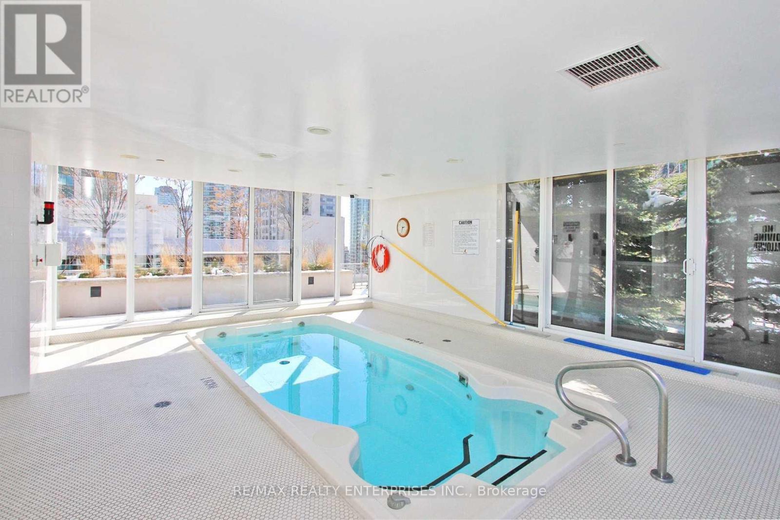 A large indoor swimming pool with a blue tiled edge.