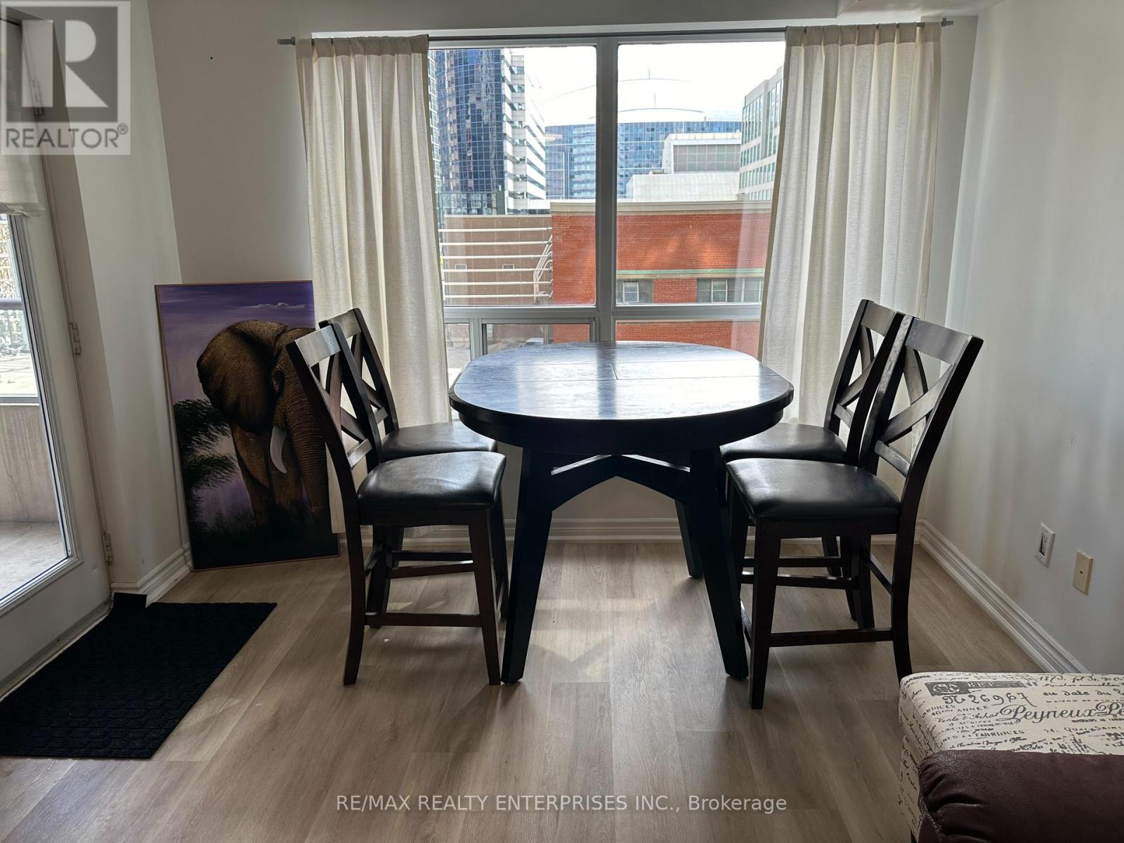A dining room with a table and chairs.
