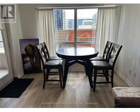 A dining room with a table and chairs.