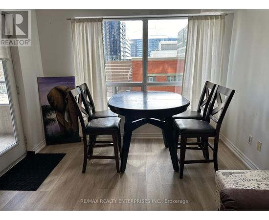 A dining room with a table and chairs.