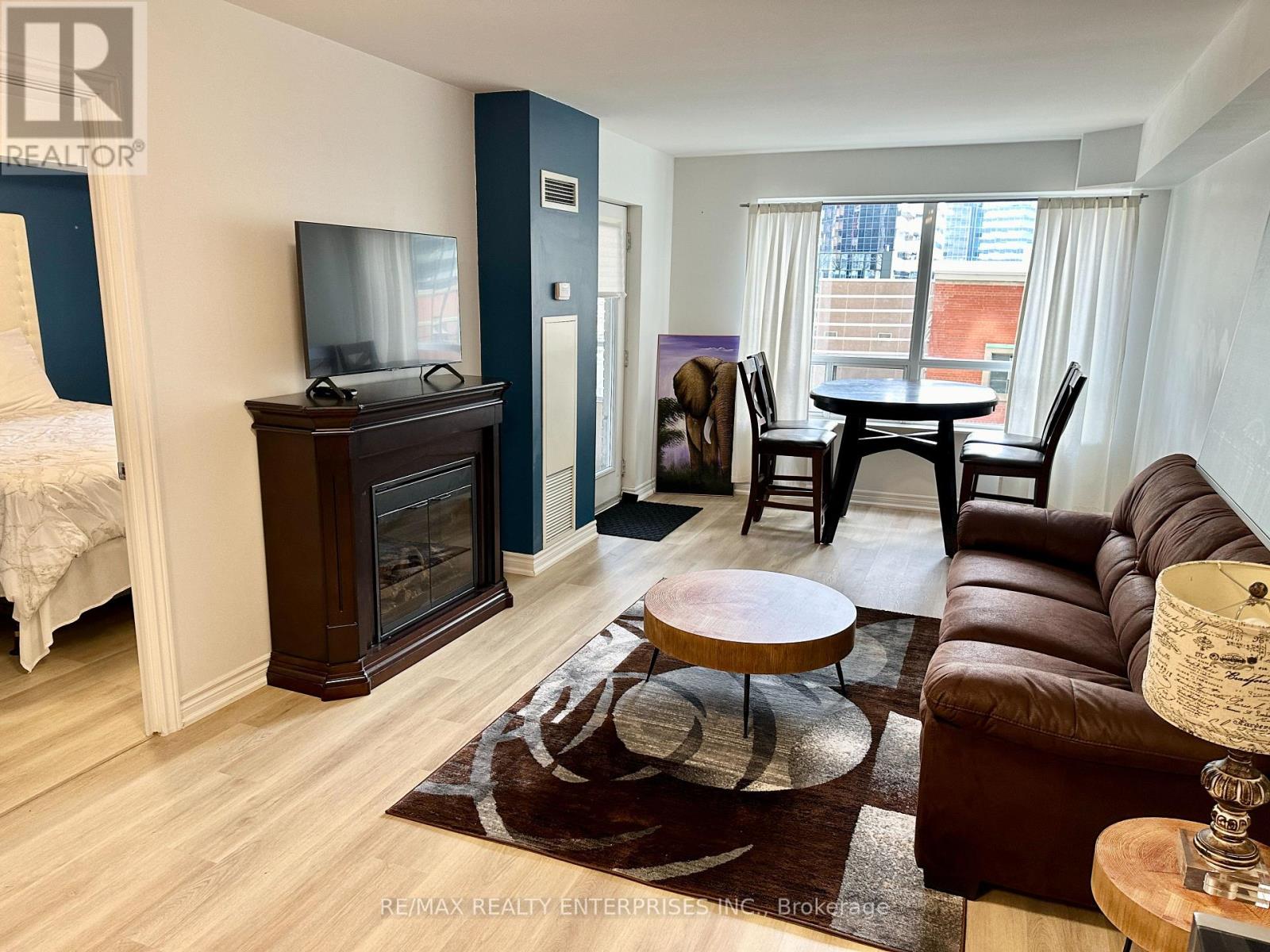 A living room with a brown leather couch and a wooden coffee table.
