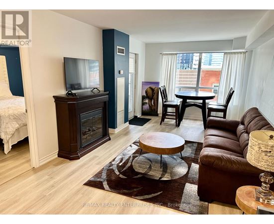 A living room with a brown leather couch and a wooden coffee table.