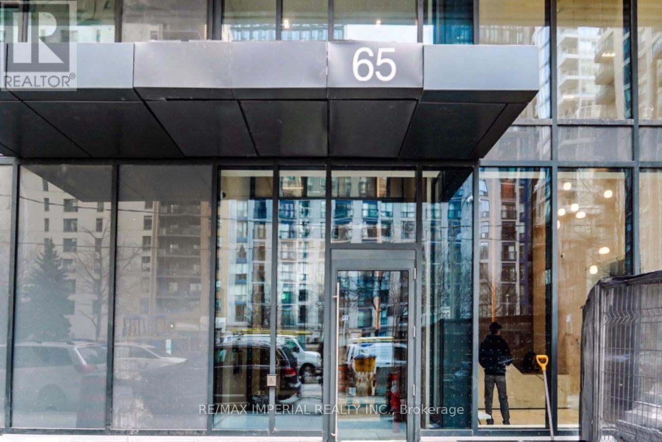 The entrance to a building with a glass door and a sign that reads "REALTOR".