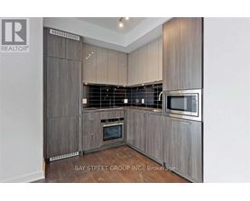 A modern kitchen with wooden cabinets and stainless steel appliances.