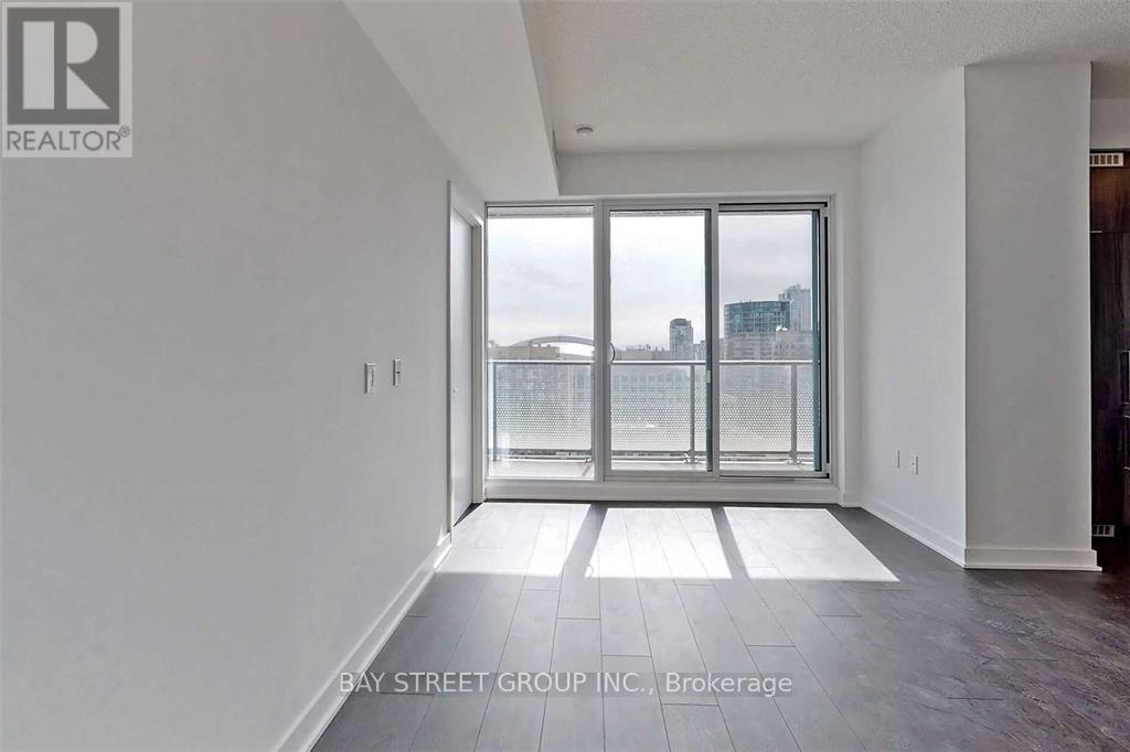 A spacious room with a view of the city through a large window.