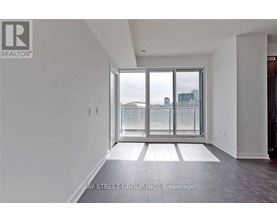 A spacious room with a view of the city through a large window.