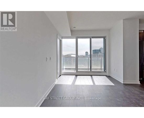 A spacious room with a view of the city through a large window.